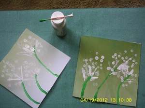 Using other end of the q tip, add blowing dandelion seeds as dots.