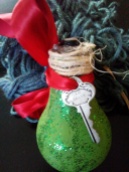 Up-cycle dead light bulb with paint and Glitter. Add bow, vintage key and jute twine again.